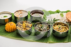 South IndianÂ style lunch or dinner meal or food served with a selection of recipes over banana leaf